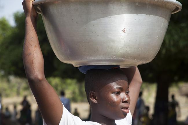 WASH needs strong systems not strong necks: girl carrying water vessel on head