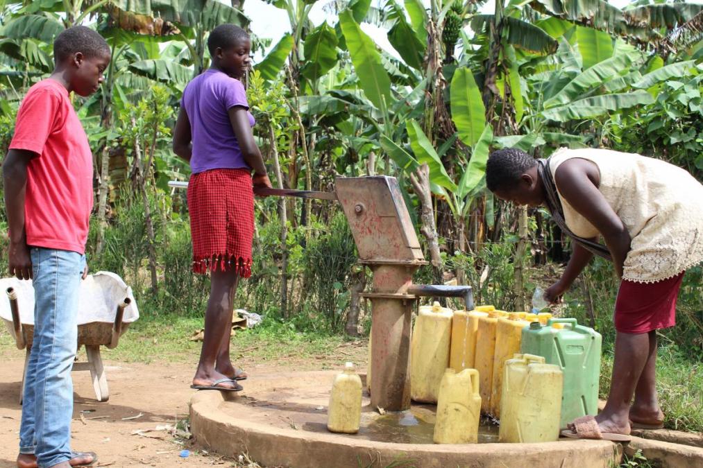Siblings fetching water in Kabarole District