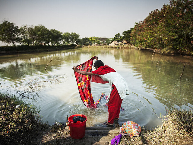 Women washing laundry in a river in Bangladesh