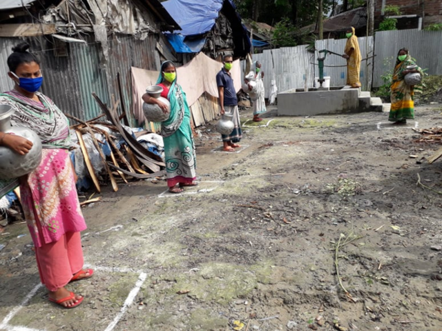COVID-19 - Social distancing at a handpump in Bangladesh.