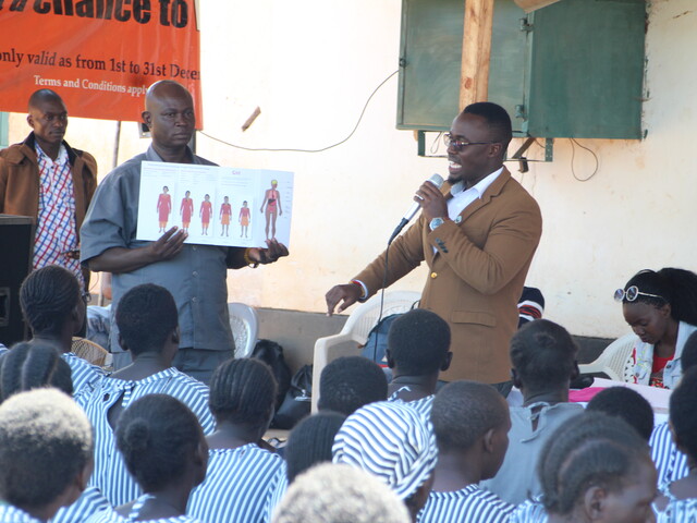 Daniel Karanja telling schoolchildren about menstrual hygiene management
