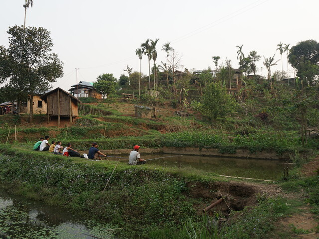 Villagers fishing in their newly expanded pond. Meghalaya, India