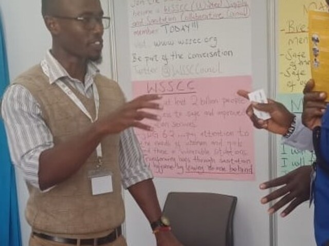 Daniel Karanja at the WSSCC booth during the Sanitation Conference in Kenya