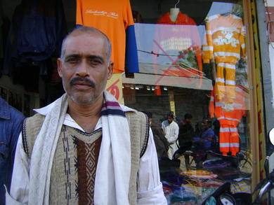 Shubhash Chandro Shaha outside his late father’s sari shop at Sahapur Bazaar